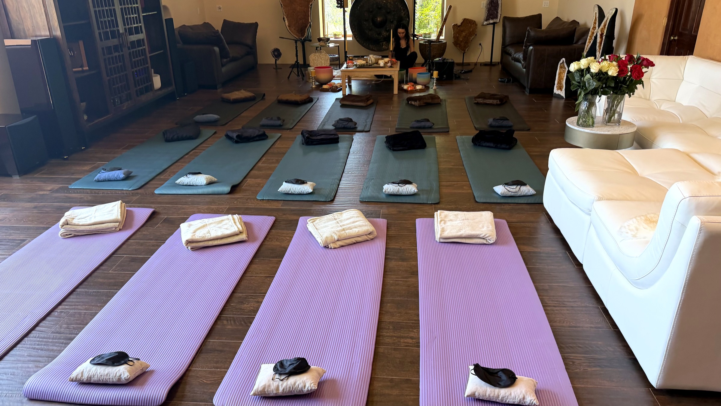 The ranch studio prepared with mats, blankets, flowers, bowls, and gong before guests arrive