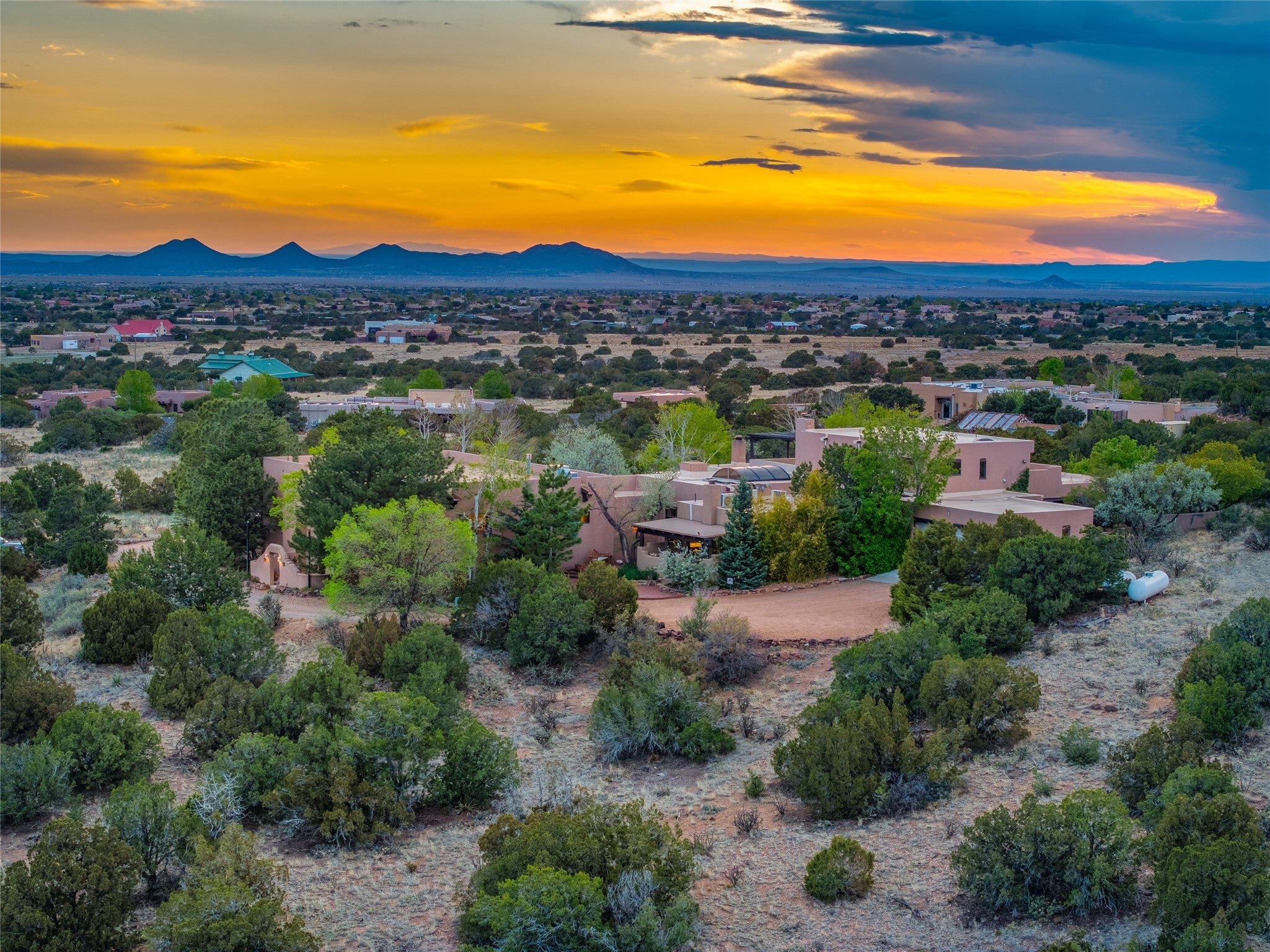 Rancho Los Dragones Dorados beneath a New Mexico sunset