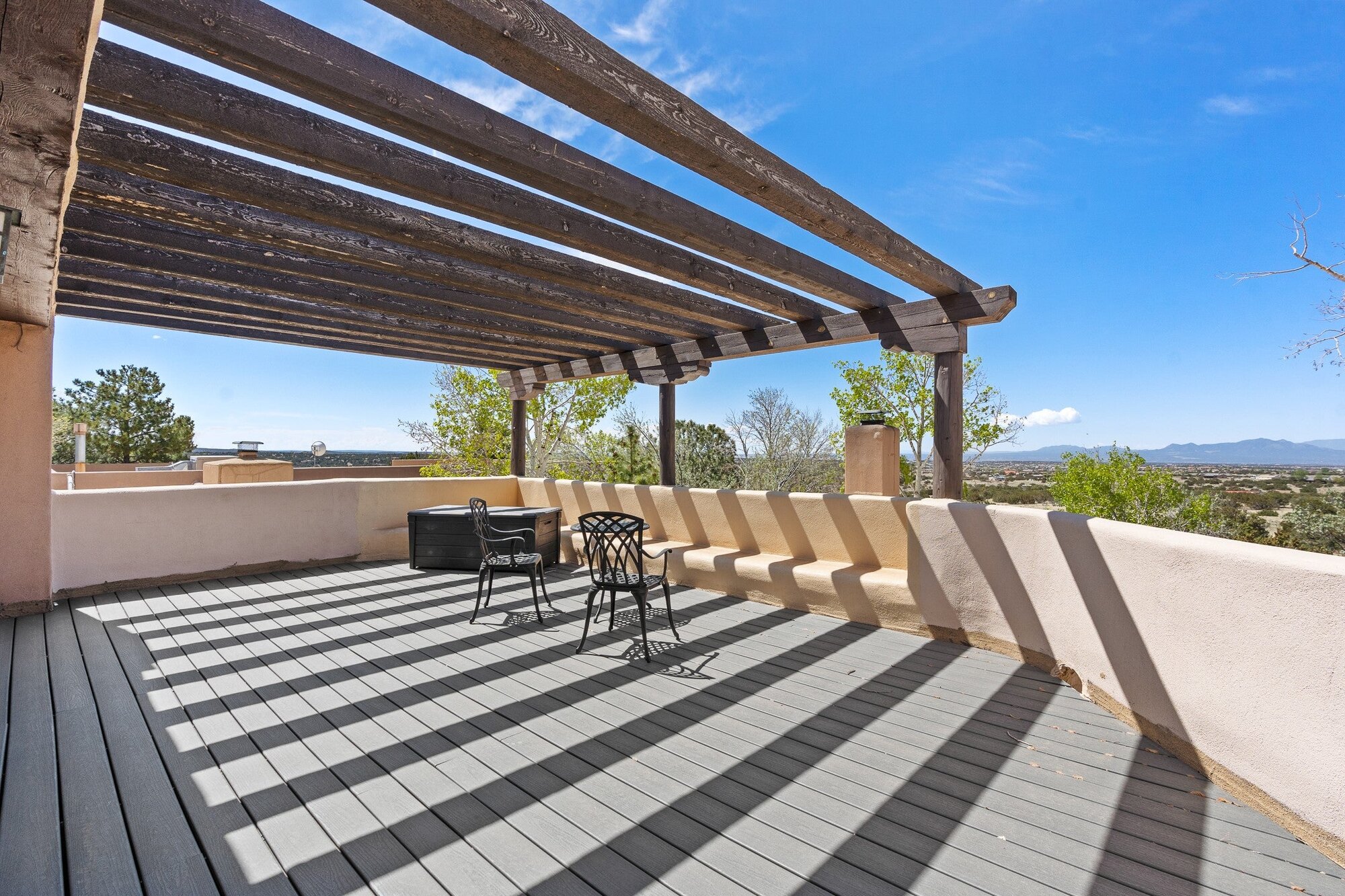 A shaded ranch terrace opening toward the high-desert landscape