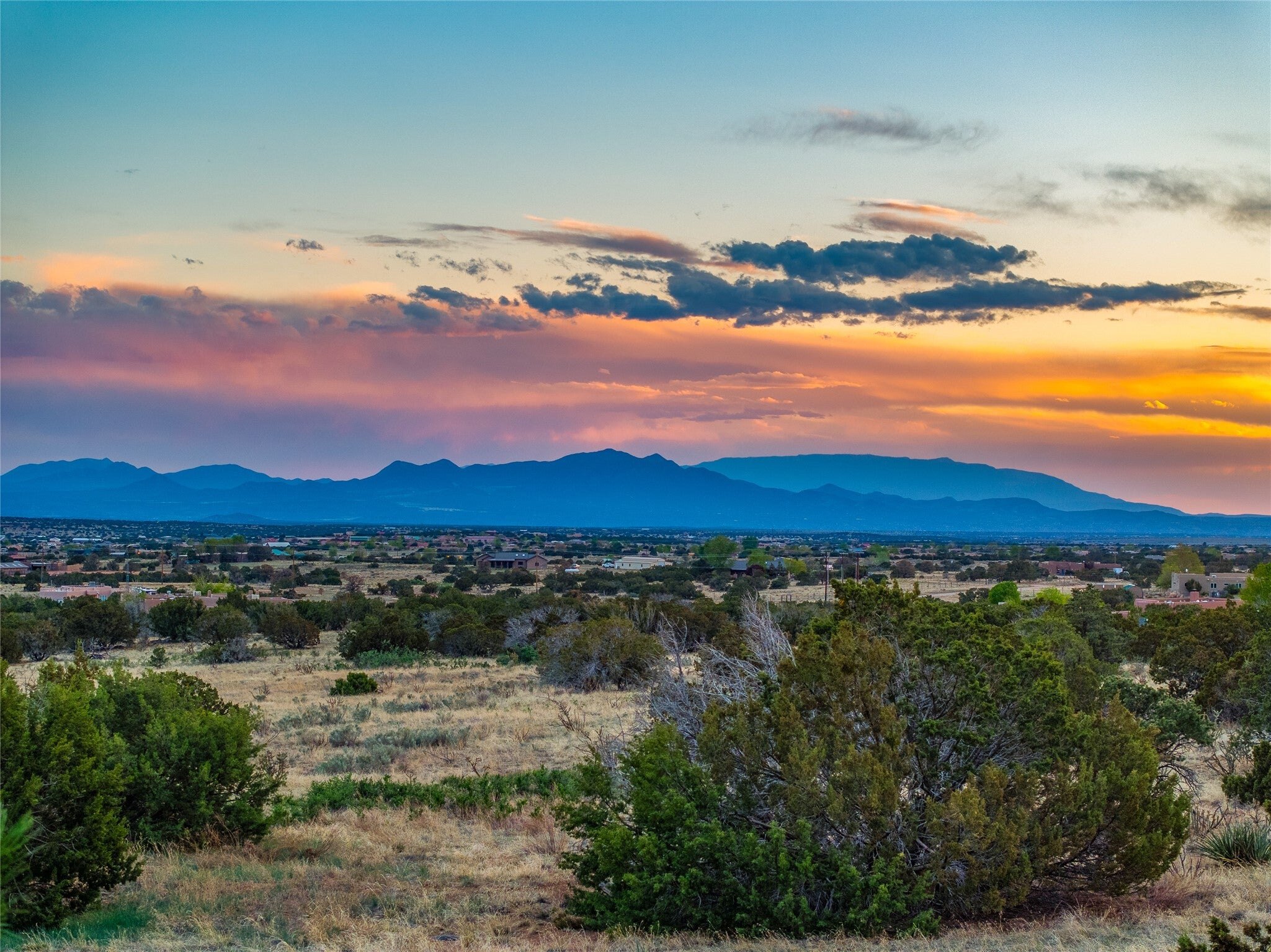 The western sky glowing over the ranch at sunset